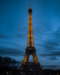 Low angle view of illuminated tower against sky