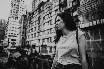 Young woman against building in city