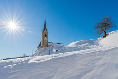 Low angle view of cross against blue sky