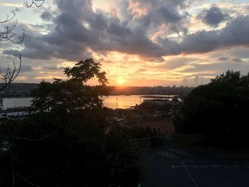 Scenic view of city against sky during sunset