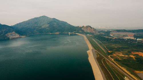 Scenic view of river amidst mountains against sky