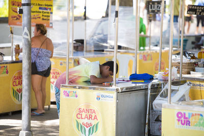 High angle view of woman with text at market