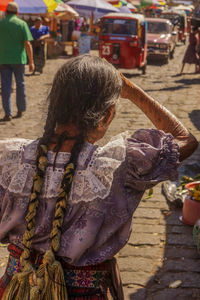 Rear view of woman holding statue