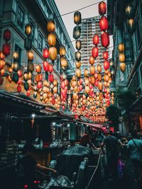 Illuminated lanterns hanging in store