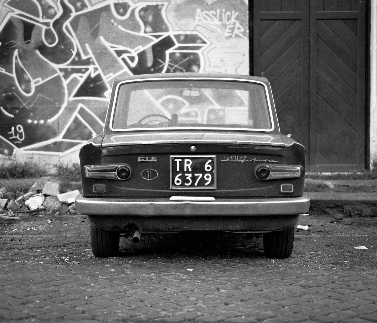 retro styled, text, communication, car, mode of transportation, old, no people, number, motor vehicle, western script, land vehicle, transportation, day, abandoned, architecture, outdoors, graffiti, wall - building feature, vintage car