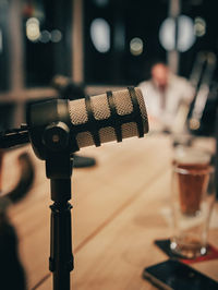 Podcast microphone close up texture with blurry person in background