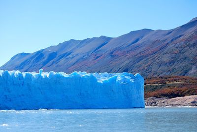 Glaciers melting in river against mountains during winter