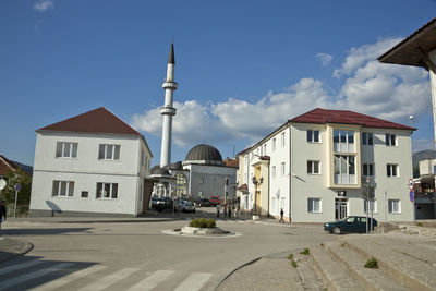 Street amidst buildings in city against sky