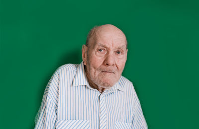 Portrait of a man against green background