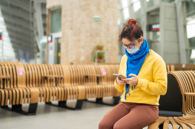 Full length of man using mobile phone