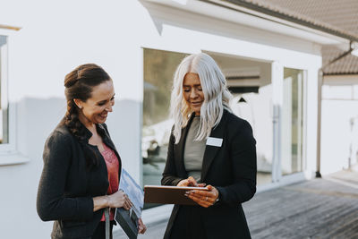 Estate agent showing woman house