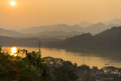 Scenic view of lake against sky during sunset