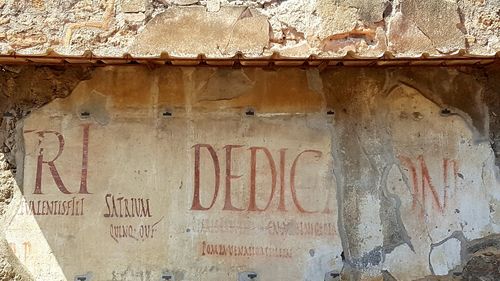 Close-up of text on brick wall