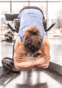 Rear view of woman exercising in gym