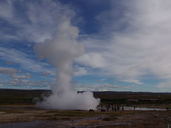 Panoramic view of blowhole on landscape against sky