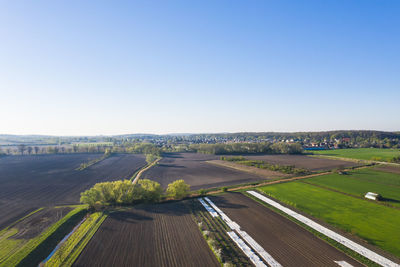 Scenic view of agricultural field against clear sky