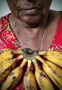 Close-up of woman with fruits