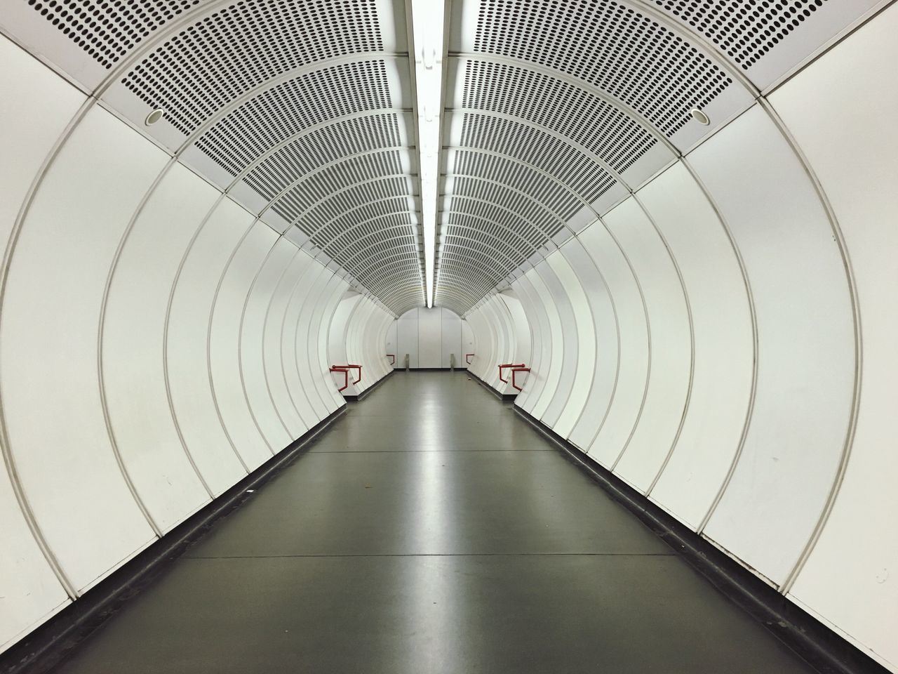 indoors, ceiling, architecture, built structure, modern, diminishing perspective, pattern, the way forward, lighting equipment, wall - building feature, railing, design, vanishing point, directly below, illuminated, low angle view, empty, corridor, no people, white color