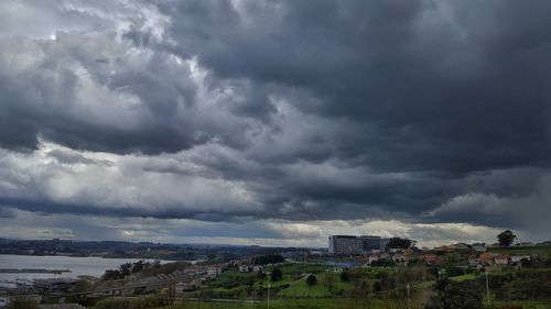 Cityscape against cloudy sky