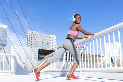 Full length of woman on railing against sky