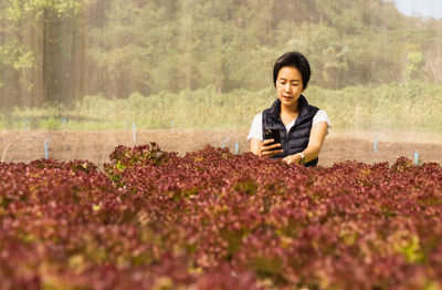 Portrait of young woman sitting on field