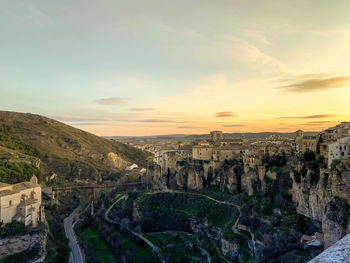 High angle view of buildings in city during sunset