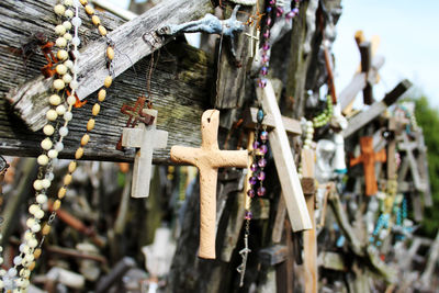 Close-up of cross hanging on wood