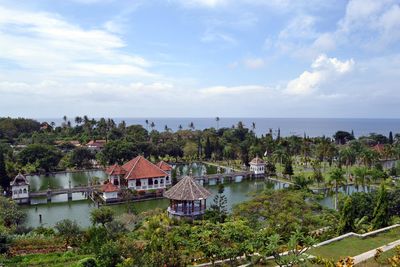 High angle view of houses by sea against sky