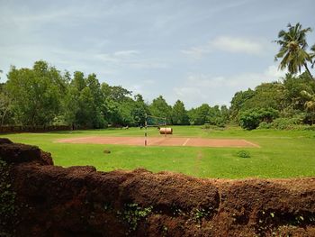 Scenic view of golf course against sky