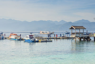 Scenic view of sea and mountains against sky