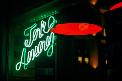 Low angle view of illuminated sign at night