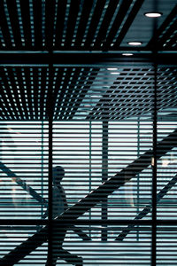 Silhouette person walking on staircase in building