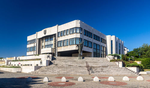 Low angle view of building against clear blue sky