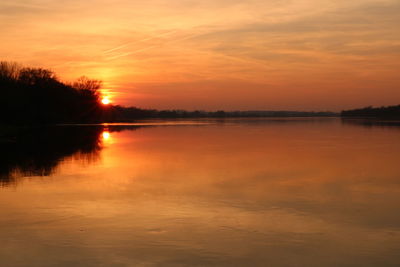 Scenic view of lake against romantic sky at sunset