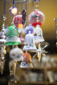 Close-up of illuminated lighting equipment hanging at store