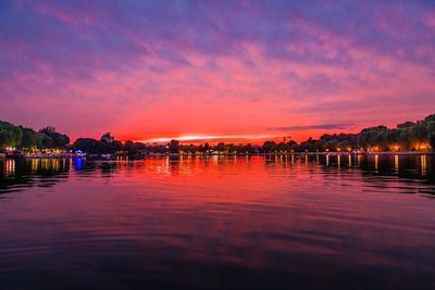 Scenic view of lake against romantic sky at sunset