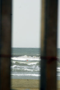 Scenic view of sea against sky seen through window