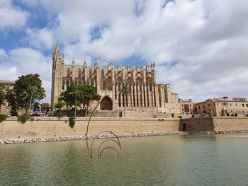 Buildings against cloudy sky
