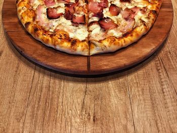 High angle view of pizza on cutting board