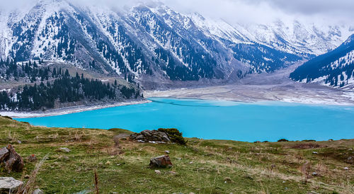 Scenic view of lake and mountains against sky