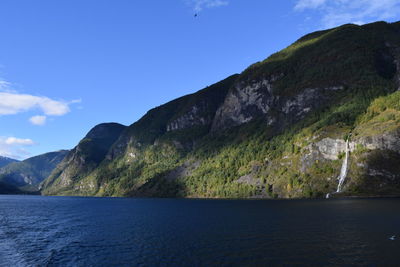 Scenic view of sea and mountains against sky