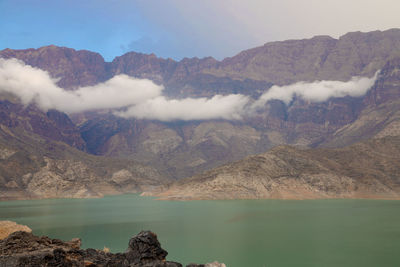 Scenic view of lake and mountains against sky