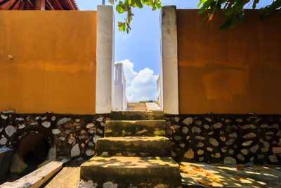 Stack of stone wall by building