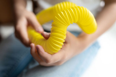 Anti stress sensory pop tube toys in a children's hands. a little kids plays with a poptube toy