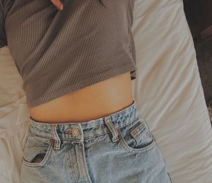 High angle view of woman relaxing on bed at home