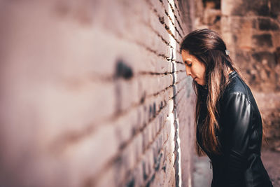 Woman standing against wall