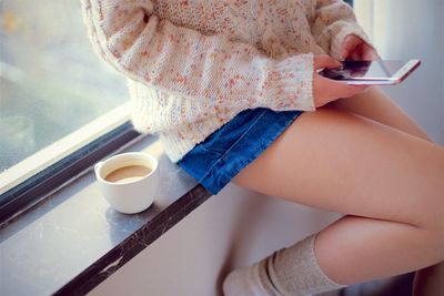 High angle view of woman holding coffee cup