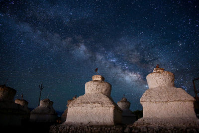 Statue against sky at night