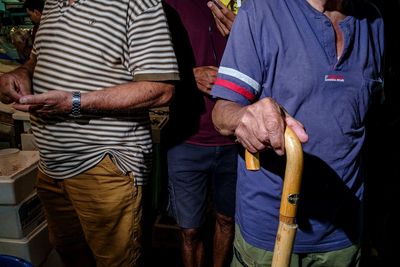 Rear view of people standing in workshop