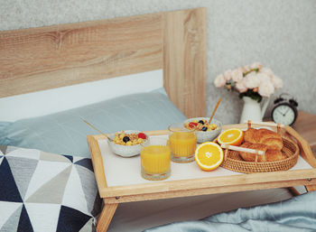 Romantic breakfast with coffee, waffles, orange juice and rose flowers.